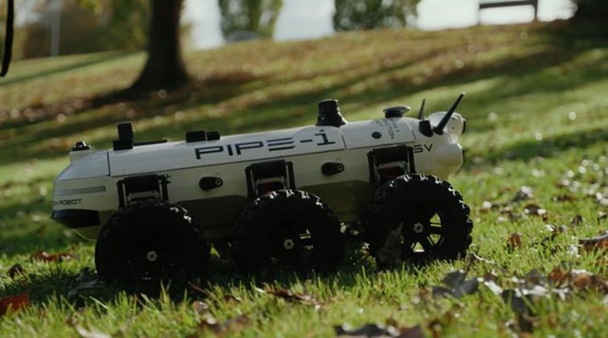 PIPE-i, a white six-wheeled robotic surveying vehicle